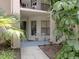 Cozy condo entrance with seating area and tropical foliage at 4315 45Th W Ave # 103, Bradenton, FL 34210