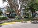A well-maintained building stands beautifully behind a mature shade tree and manicured landscaping at 4315 45Th W Ave # 103, Bradenton, FL 34210