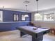 Game room featuring a pool table with modern pendant lights, complemented by a blue accent wall at 4315 45Th W Ave # 103, Bradenton, FL 34210