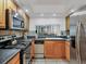 Kitchen with stainless appliances, tile flooring, and a pass-through to living room at 4315 45Th W Ave # 103, Bradenton, FL 34210