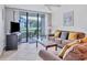 Comfortable living room with stylish furniture, ceiling fan, and access to outdoor patio at 4315 45Th W Ave # 103, Bradenton, FL 34210
