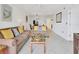 Spacious living room with comfortable sofas, neutral decor, and view into dining area at 4315 45Th W Ave # 103, Bradenton, FL 34210