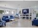 Relaxing library area featuring a comfy couch, bookshelf, and large screen TV at 4315 45Th W Ave # 103, Bradenton, FL 34210