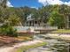 A serene community pool features lounge chairs and connects to the building with a charming bridge over a small waterway at 4315 45Th W Ave # 103, Bradenton, FL 34210