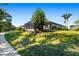 Expansive backyard with a screened lanai, lush greenery, and mature trees for privacy at 437 Chantilly Trl, Bradenton, FL 34212