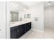 Bathroom featuring dual sinks, dark wood cabinets, and a glass shower at 437 Chantilly Trl, Bradenton, FL 34212