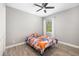 This bedroom features a ceiling fan, wood-look flooring, window and closet at 437 Chantilly Trl, Bradenton, FL 34212