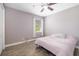 This bedroom features a ceiling fan, wood-look flooring and window with natural light at 437 Chantilly Trl, Bradenton, FL 34212