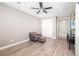 Bedroom featuring a comfortable armchair, footstool, and wood-look floors at 437 Chantilly Trl, Bradenton, FL 34212