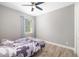 This bedroom features a ceiling fan, wood-look flooring, window and closet at 437 Chantilly Trl, Bradenton, FL 34212