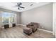 Bedroom featuring a comfortable armchair, footstool, and wood-look floors at 437 Chantilly Trl, Bradenton, FL 34212