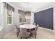 Bright dining room with stylish chandelier and views from the windows at 437 Chantilly Trl, Bradenton, FL 34212