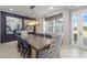 Elegant dining room features a modern chandelier, striking artwork, and ample seating for gatherings at 437 Chantilly Trl, Bradenton, FL 34212
