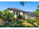 Well-maintained backyard featuring lush landscaping and a screened-in pool at 437 Chantilly Trl, Bradenton, FL 34212