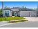 Charming single-Gathering home with a three-car garage, beautiful lawn and landscaping at 437 Chantilly Trl, Bradenton, FL 34212