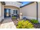 Inviting front porch with comfortable seating, a water feature, and well-maintained landscaping at 437 Chantilly Trl, Bradenton, FL 34212