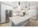 Bright kitchen with white cabinets, a large island, stainless steel appliances, and modern pendant lights at 437 Chantilly Trl, Bradenton, FL 34212
