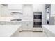 Elegant kitchen showcasing white cabinets, stainless steel appliances, and an open layout at 437 Chantilly Trl, Bradenton, FL 34212