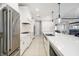 Beautiful kitchen features white cabinets, stainless appliances, a large island, and an open layout to the living area at 437 Chantilly Trl, Bradenton, FL 34212