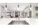 Open kitchen with a large island, modern sink fixtures, and seamless flow into the living area at 437 Chantilly Trl, Bradenton, FL 34212