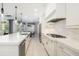 Contemporary kitchen featuring stainless steel appliances, white cabinetry, and an open layout to the dining area at 437 Chantilly Trl, Bradenton, FL 34212