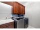 Laundry room with modern washer and dryer, cabinets, countertop and sink at 437 Chantilly Trl, Bradenton, FL 34212