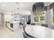Open-concept living area with kitchen island, dining space, and pendant lighting creates a welcoming atmosphere at 437 Chantilly Trl, Bradenton, FL 34212
