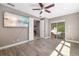 Living room with sliding glass doors to the pool and a mounted TV at 437 Chantilly Trl, Bradenton, FL 34212