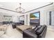 Comfortable living room with a large TV, stylish decor, and an open view to the dining area at 437 Chantilly Trl, Bradenton, FL 34212