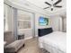 Main bedroom with a ceiling fan, windows with curtains, and a television at 437 Chantilly Trl, Bradenton, FL 34212