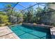 Sparkling screened-in pool with brick paver surround, perfect for relaxing and entertaining outdoors at 437 Chantilly Trl, Bradenton, FL 34212