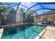 Relaxing screened pool with brick pavers and views of the surrounding trees and blue skies at 437 Chantilly Trl, Bradenton, FL 34212