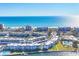 Aerial view of a waterfront community featuring stunning ocean views, white buildings, and lush landscaping at 4380 Exeter Dr # 304, Longboat Key, FL 34228