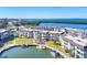 Aerial view of waterfront condos with boat docks on a sunny day with beautiful water views at 4380 Exeter Dr # 304, Longboat Key, FL 34228