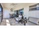 Screened balcony with outdoor seating and a small table, accessible via sliding doors at 4380 Exeter Dr # 304, Longboat Key, FL 34228