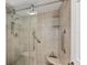 Bathroom featuring a tiled shower with a glass door and grab bars at 4380 Exeter Dr # 304, Longboat Key, FL 34228