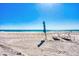 Serene beach scene featuring lounge chairs and an umbrella on the sandy shore at 4380 Exeter Dr # 304, Longboat Key, FL 34228