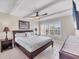 Bedroom with a large bed, ceiling fan, neutral decor, and a window at 4380 Exeter Dr # 304, Longboat Key, FL 34228