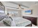 Bedroom featuring a bed, a ceiling fan, and a TV screen at 4380 Exeter Dr # 304, Longboat Key, FL 34228