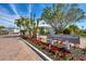 Community sign for Longboat Harbour featuring lush landscaping and palm trees on a sunny day at 4380 Exeter Dr # 304, Longboat Key, FL 34228