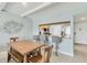 Bright dining area with a view of the kitchen bar and stainless refrigerator at 4380 Exeter Dr # 304, Longboat Key, FL 34228
