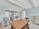 Well-lit dining area next to an open kitchen with stainless appliances at 4380 Exeter Dr # 304, Longboat Key, FL 34228