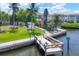Scenic dock view with an American flag and seating; perfect for relaxing by the water at 4380 Exeter Dr # 304, Longboat Key, FL 34228