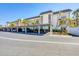 Condo building exterior displaying covered parking and lush, mature tropical landscaping at 4380 Exeter Dr # 304, Longboat Key, FL 34228