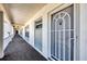 Hallway view showing unit H304 with secure front door and clean, well-maintained corridor at 4380 Exeter Dr # 304, Longboat Key, FL 34228