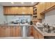 Kitchen featuring light wood cabinetry, stainless steel dishwasher, and granite counters at 4380 Exeter Dr # 304, Longboat Key, FL 34228