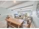 Open-concept living area with tile floors, ceiling beams, and sliding glass doors to the balcony at 4380 Exeter Dr # 304, Longboat Key, FL 34228