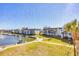 Scenic water view from unit overlooking boat docks, palm trees, and tropical landscaping at 4380 Exeter Dr # 304, Longboat Key, FL 34228