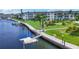 Waterfront area featuring boat docks, lush lawns, and walking paths at 4380 Exeter Dr # 304, Longboat Key, FL 34228