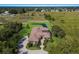 Aerial view of grand home on sprawling lot with lush landscaping, pond, and private screened-in lanai at 4610 13Th W St, Palmetto, FL 34221